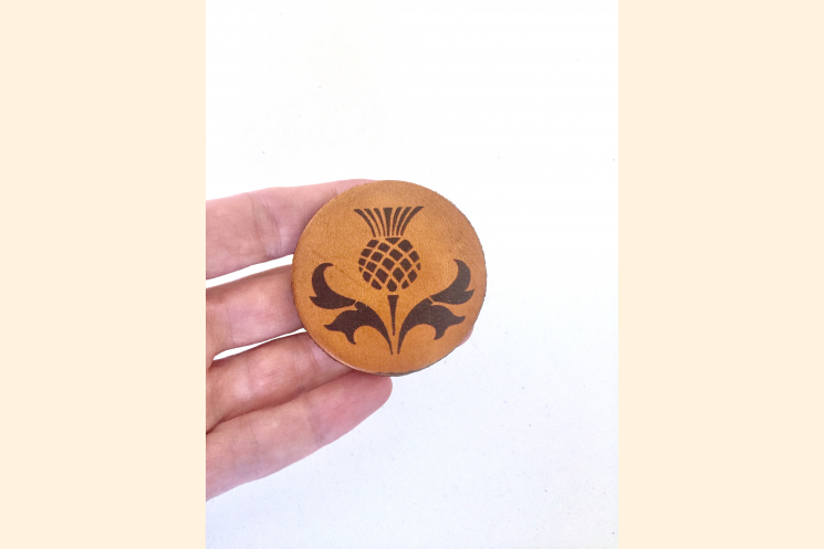Scotland Thistle Leather Magnet on Three Fingers of Hand for Scale