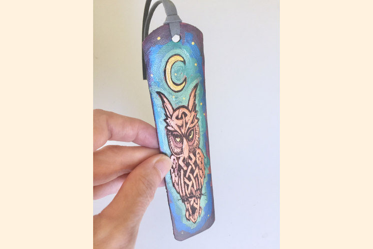 Blue Celtic Owl Bookmark with Tassel held with hand for scale