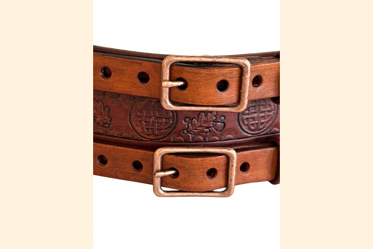 Front view of brown leather double buckle belt with Celtic knot, detail